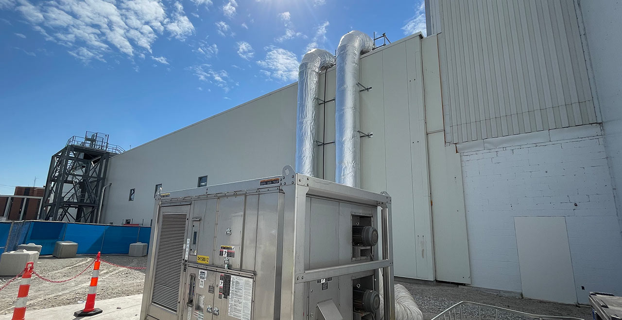 Heavy industrial HVAC equipment at REIC Specialty Rentals construction site.