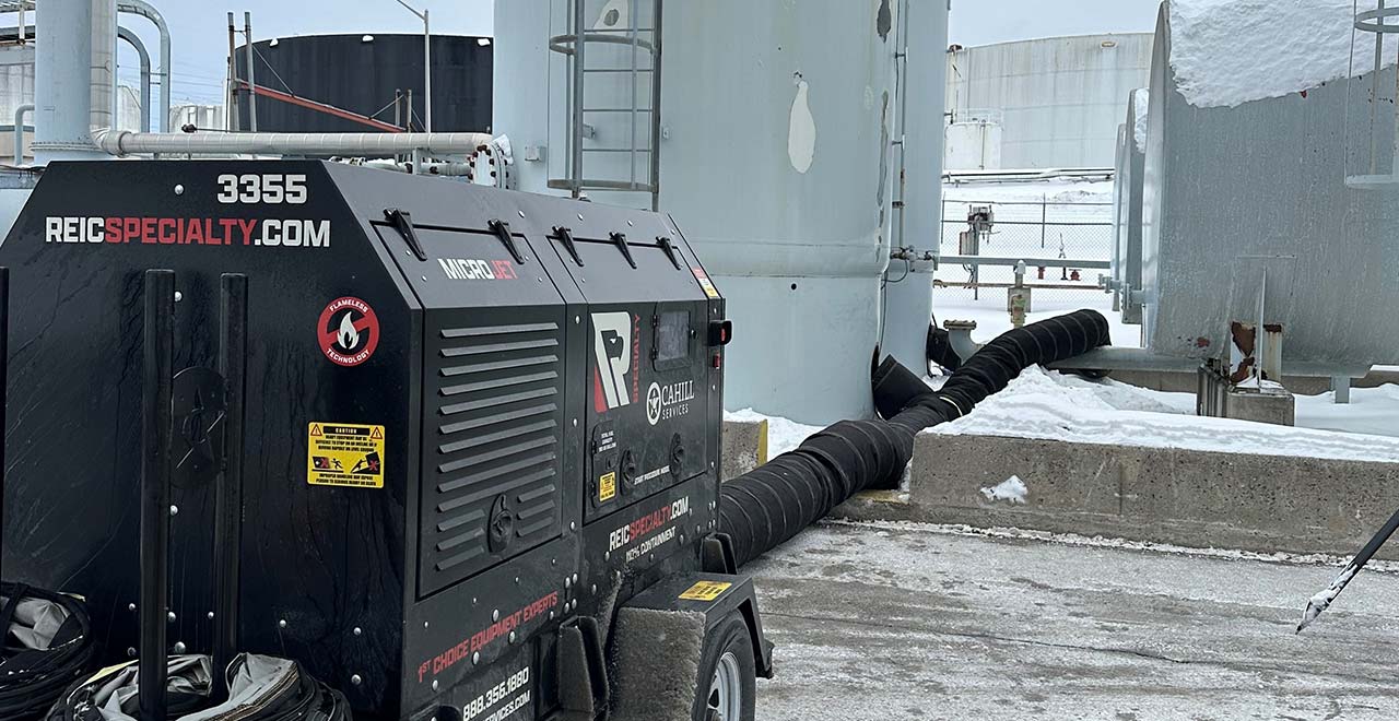 Industrial equipment rental on icy rooftop for construction projects.